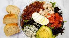 Cobb Salad · Chopped Romaine and Spring Mix, Cherry Tomatoes, Crisp Bacon, Sliced Egg, Avocado, Grilled Chicken, Crumbled Bleu Cheese, and Bleu Cheese Dressing on the side.