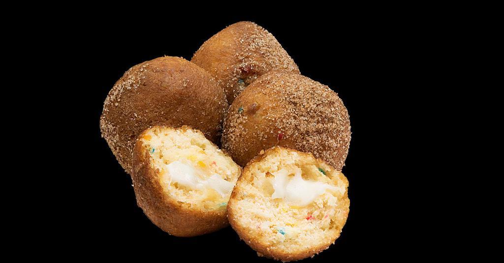 BIRTHDAY CAKE DONUT HOLES · Warm birthday cake donut holes filled with colorful confetti and creamy vanilla frosting, dusted in cinnamon sugar. Serving size: 4 donut holes