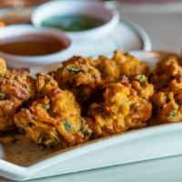 Vegetable Pakoras · Fresh veggie fritters made with spinach, potatoes, onions and cauliflower
(Six pieces.)
