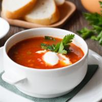 Tomato Soup · Thickened purée of tomato with croutons, fresh cream and spices.