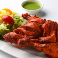 Half Tandoori Chicken (2 pcs) · 1 leg and 1 breast. Half a chicken marinated in yogurt with special herbs and spices.