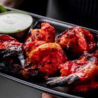 Tandoori Shrimp · Finely marinated Shrimp seasoned with chopped onions, garlic, ginger, herbs and spices baked...