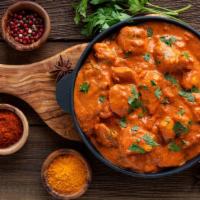 Butter Chicken · Tandoori chicken pieces cooked in creamy tomato sauce, topped with butter.