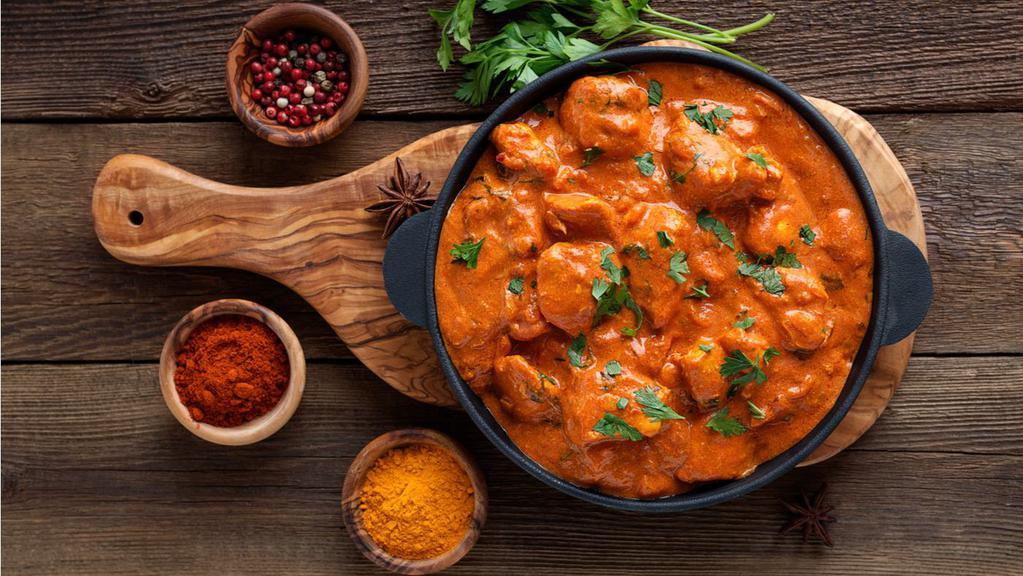 Butter Chicken · Chicken cooked with organic onion & tomato with Indian herbs & spices.