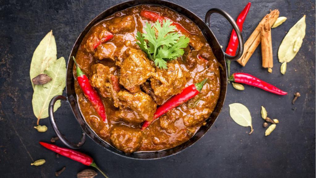 Lamb Curry · Lamb cooked with organic onion & tomato with Indian herbs & spices.