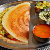 Mysore Masala Dosa · Thin crispy crepe spread with authentic mysore chutney and filled with potato curry.