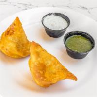 2 Pieces Vegetable Samosa · Light, flaky pastry stuffed with a mixture of potatoes and peas served with chutney sauce.