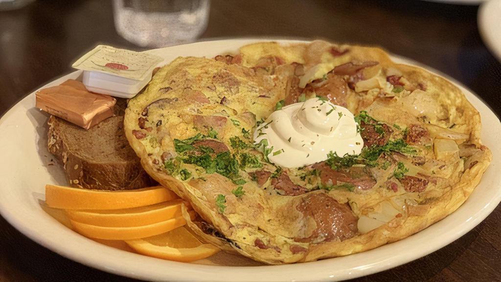 German Omelet · Omelet with potatoes, onions, bacon, sour cream. All omelets come with a side of German bread, butter and jam.