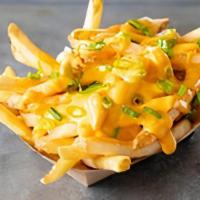 Cheese Fries · Topped with a creamy cheese sauce made with jalapeños & green onions.
