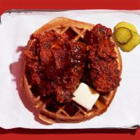 Nashville Hot Fried Chicken And Waffle · Nashville-style spicy hot, crispy fried chicken leg and thigh on a fluffy waffle with maple ...