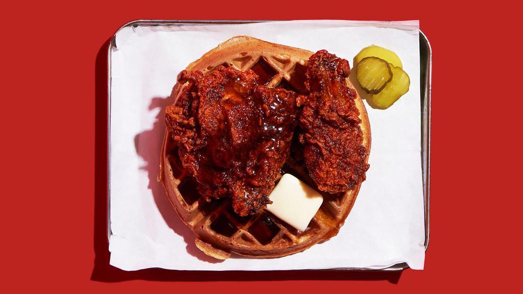 Nashville Hot Fried Chicken And Waffle · Nashville-style spicy hot, crispy fried chicken leg and thigh on a fluffy waffle with maple syrup and butter.