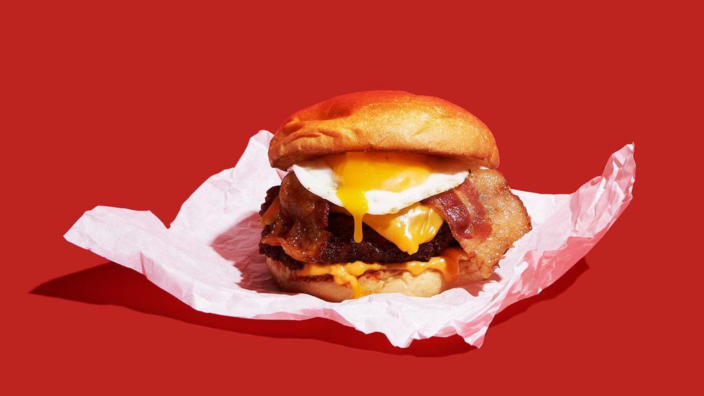 Nashville Hot Breakfast Fried Chicken Sandwich · Nashville-style spicy hot, crispy fried chicken breast with bacon, melted cheddar, spicy mayo, and a fried egg on a brioche bun.