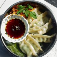 Chicken Dumpling · Steamed chicken and vegetables dumplings served with flavored soy sauce.