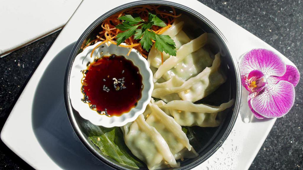 Chicken Dumpling · Steamed chicken and vegetables dumplings served with flavored soy sauce.