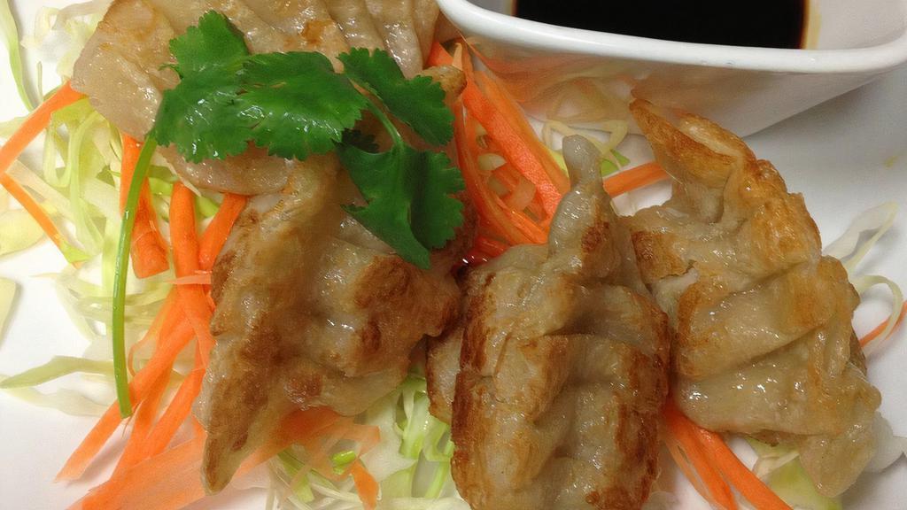 Pot Stickers · Fried chicken and vegetables pot stickers served with flavored soy dipping sauce.
