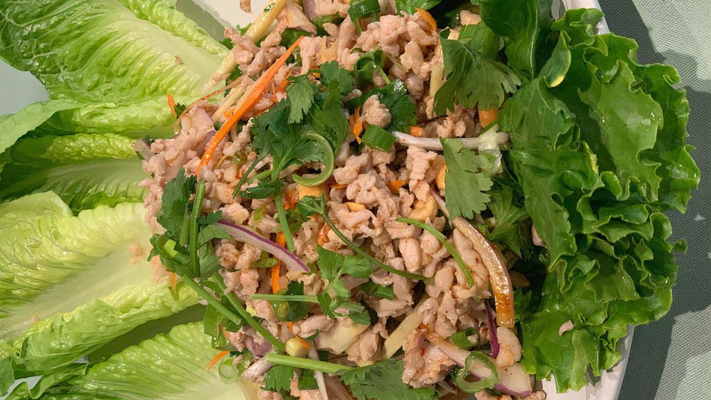 Thai Lettuce Wrap · Minced chicken or tofu with ginger, peanut, chili, lime sauce, herbs and spices. Served with lettuce.