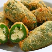 Jalapeno Poppers · Six pieces crispy golden breaded jalapenos stuffed with creamy cheese and served with a mari...