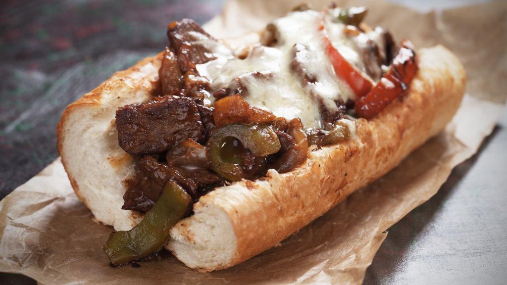 Avocado Philly Cheese Steak · Juicy steak slices, creamy cheese, avocado, mushrooms, onions, and bell peppers loaded onto fresh bread.