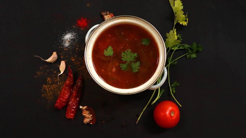Rasam · Traditional curry made with tamarind, tomatoes, spices, and aromatic herbs.