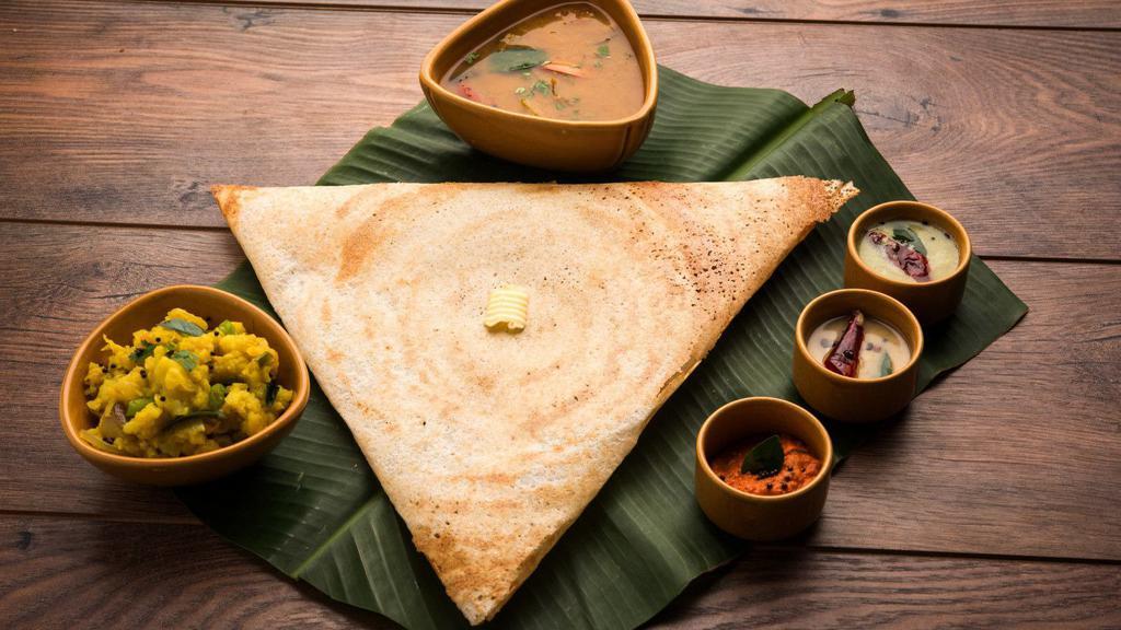 Cheese Dosa · Thin pancake made from fermented batter consisting of lentils and rice with a cheesy filling, served with three chutneys and sambar.