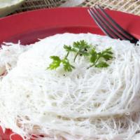 Idiyappam · Two pieces of freshly baked bread prepared from rice flour that is used to form thin noodles...