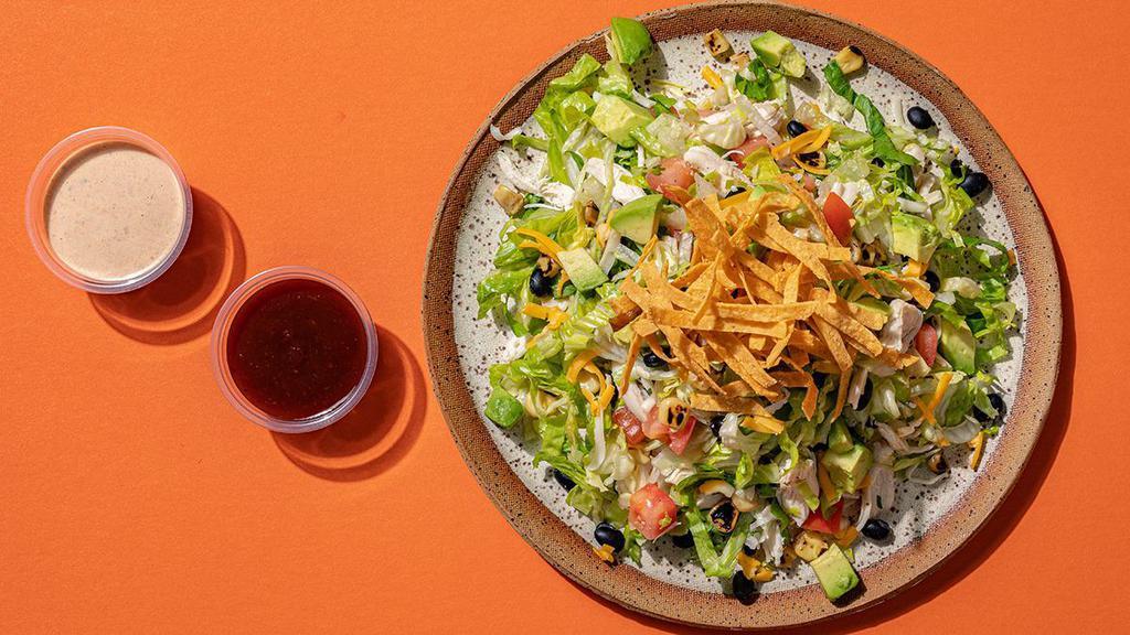 Tex-Mex Salad · hand-pulled chicken breast, black beans, shredded jack + cheddar cheeses, charred sweet corn, avocado, tomatoes, and hand-cut tortilla strips tossed with iceberg + romaine lettuce – with BBQ sauce + chipotle ranch on the side [670 cal]