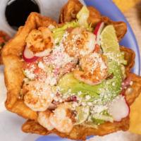 Prawn Taco Salad · Crispy Tortilla Bowl with Grilled Prawns, Beans, Rice, Mixed. Greens, Cotija Cheese, Olives,...