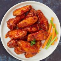 Buffalo Basher Wings · Fresh chicken wings breaded, fried until golden brown, and tossed in buffalo sauce. Served w...