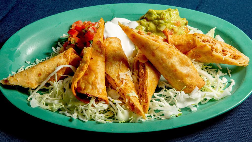 Chicken Flautas Plate · Three rolled corn tortillas, deep-fried and topped with guacamole, sour cream, pico de gallo, and monterey jack cheese.