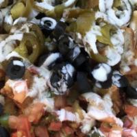 Super  Fish Nachos · Chips layered with refried beans, topped with melted cheese, guacamole, sour cream, pico de ...