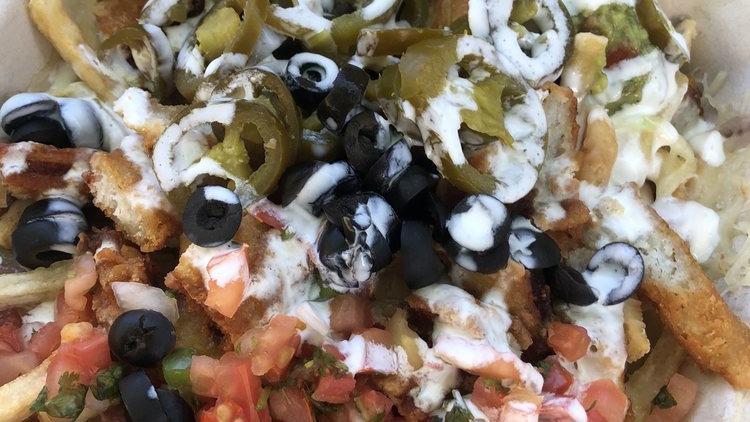 Super Meat Nachos · Chips layered with refried beans, topped with melted cheese, guacamole, sour cream, pico de gallo, olives, jalapeños, and your choice of  meat.
