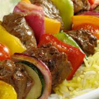 Beef Kabob Plate · Sizzling beef kabob over bed of rice, with side of salad, hummus and pita bread.