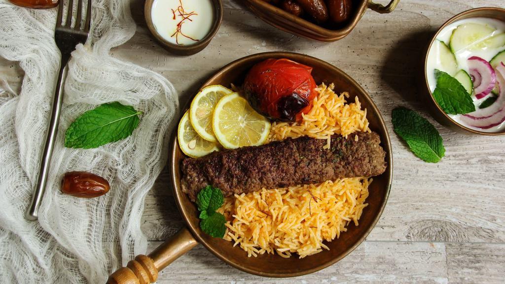 Exquisite Lamb Kabob Plate · Sizzling & Juicy lamb kabob over bed of rice, with side of salad, hummus and pita bread.