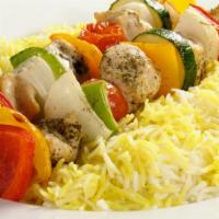 The Chicken Kabob Plate · Fresh chicken kabob sizzling over bed of rice, with side of salad, hummus and pita bread.
