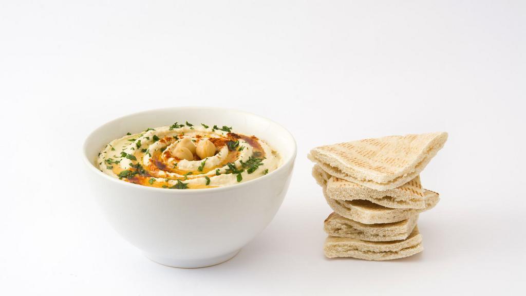 Hummus with Pita Bread · Exotic hummus dip served with side of pita bread.