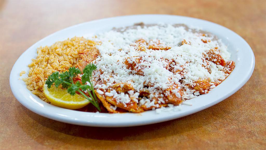 Chilaquiles · Scrambled eggs with tortilla chips and red sauce, topped with onions and cotija cheese.