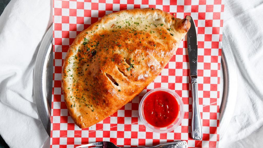 MEAT CALZONE · (homemade white sauce with sausage, pepperoni, ham, meatball and bacon on a folded pizza pie)
comes with a side of marinara sauce.

BEST SELLING
