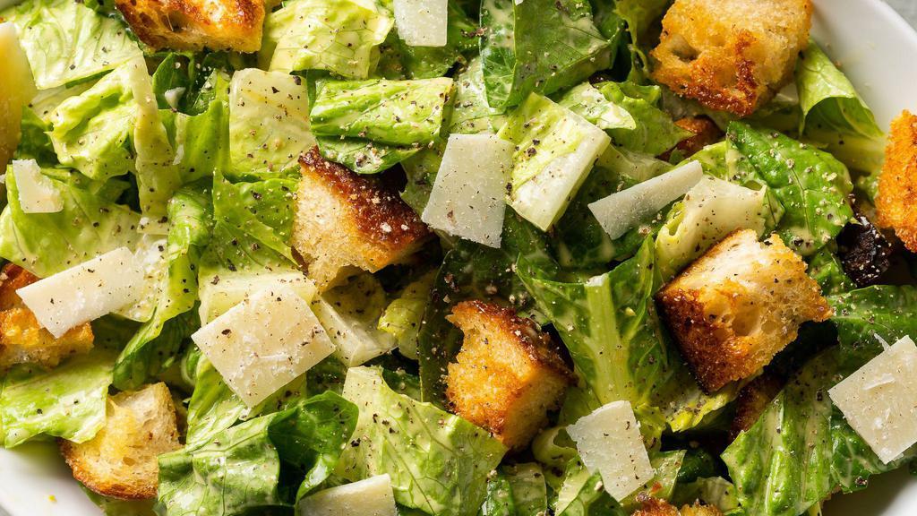 Caesar Salad · Baby hearts of romaine shaved parmesan cheese croutons and caesar dressing.