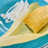 Tamales de Elote · Homemade tamale from sweet corn. Served with a side of sour cream.