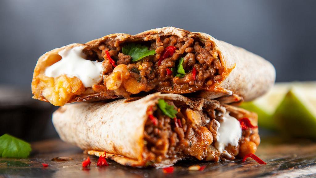 Traditional Burrito · Classic burrito with rice, beans, salsa, onions, cilantro with your choice of meat.