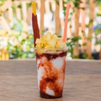Monkilada 20 Oz · Shaved ice, piña colada concentrate, chamoy and topped with fresh pineapple.