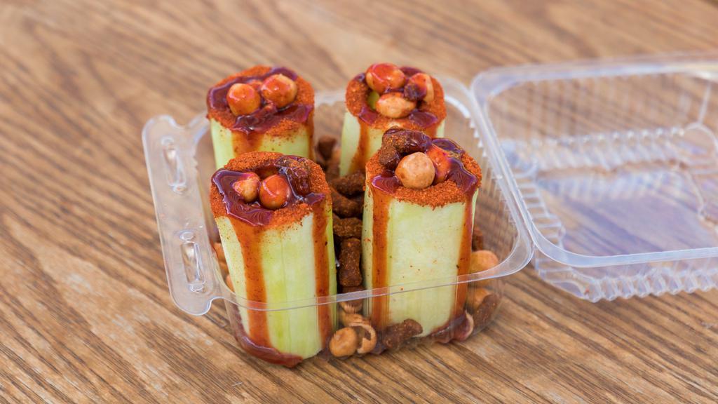 Pepino Loco · Cucumber filled with chamoy, tamarind candy and Japanese peanuts.