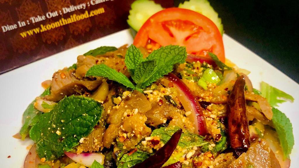 Spicy BBQ Pork Salad (Nam Tok) · Sliced Grilled Pork with Spicy Lime Dressing, Red Onions, Green Onions,  Dried Chili, Mint and Roasted Rice Powder.