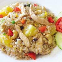 Pineapple Fried Rice · Fried rice with eggs, pineapple, raisins, cashew nuts, tomatoes, carrots, onions and green p...