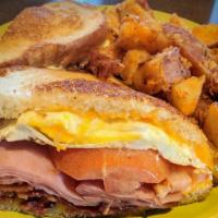 Breakfast Sandwich · Ham, bacon, fried egg, tomato, Cheddar cheese and mayo on sourdough toast.