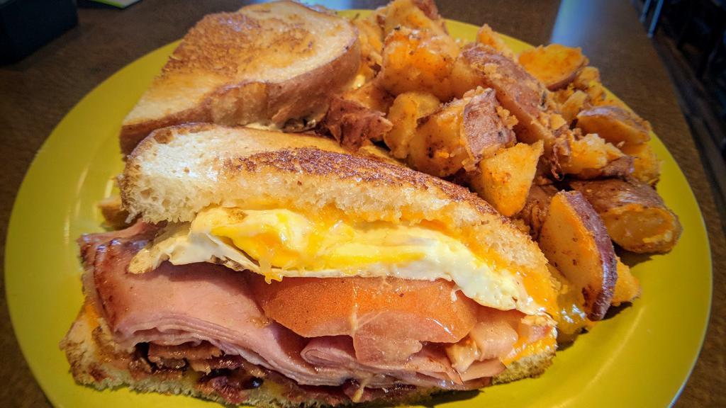 Breakfast Sandwich · Ham, bacon, fried egg, tomato, Cheddar cheese and mayo on sourdough toast.
