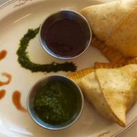 Samosa · Triangular pastry filled with potatoes, peas & deep fried.