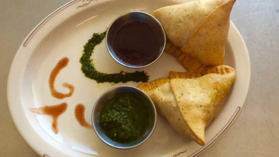Samosa · Triangular pastry filled with potatoes, peas & deep fried.