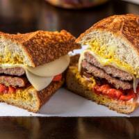 Italian Sausage Sandwich · Hot or mild italian sausage, mustard, onions, roasted peppers with provolone