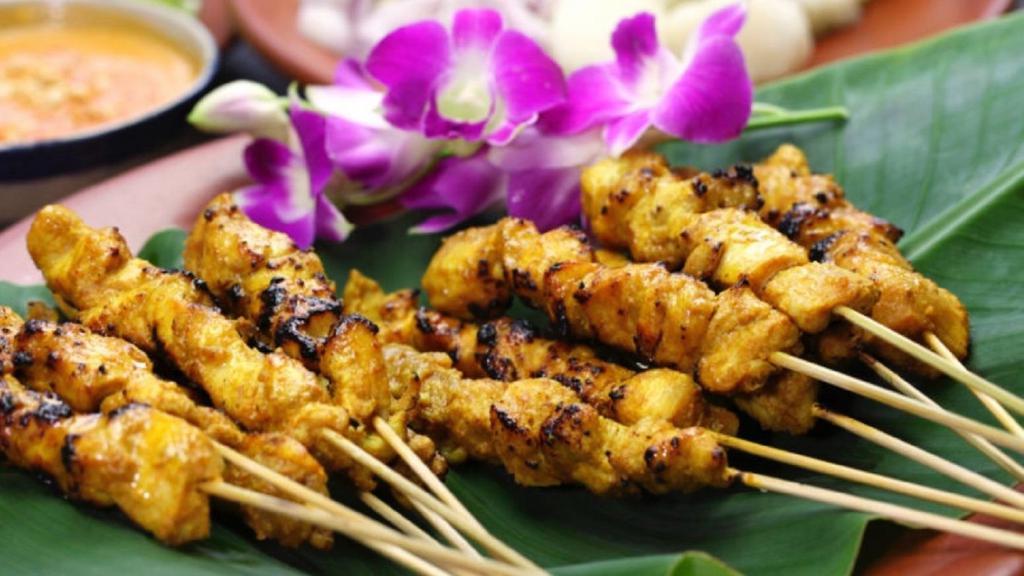 Satay (Chicken or Beef) · Grilled and marinated on skewers with peanut sauce and cucumber salad.